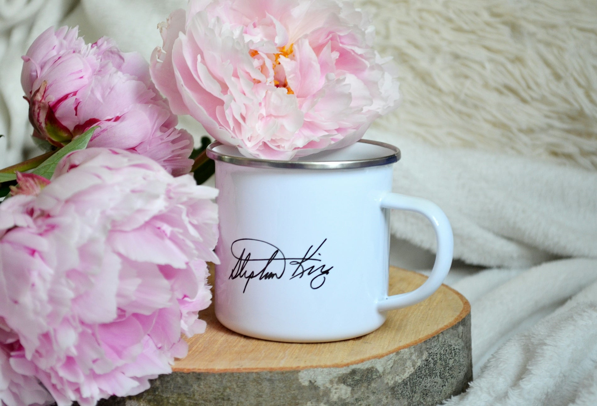 white ceramic mug on brown wooden table