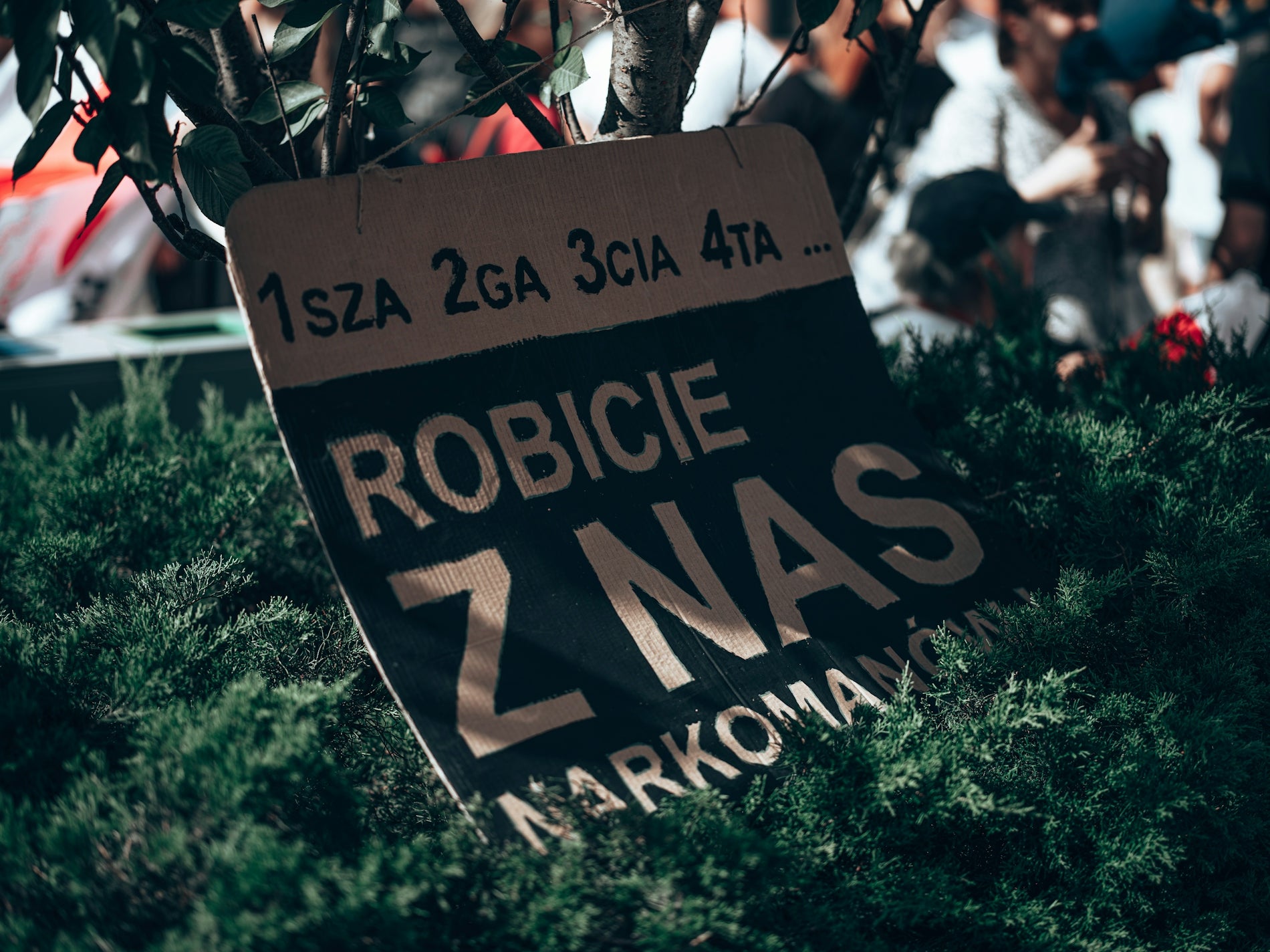 a sign in front of a crowd