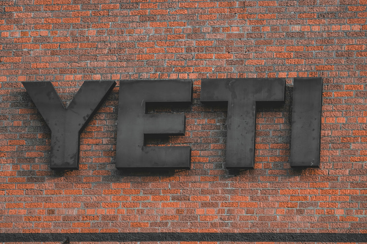 Yeti logo displayed on a brick wall.